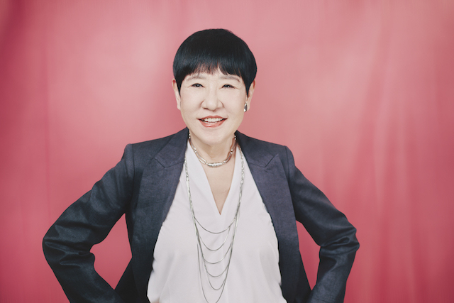ピンクの背景の前に立つ和田アキ子